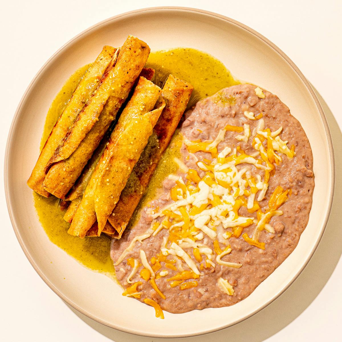 Beef Taquitos + Refried Beans by Cielito Lindo